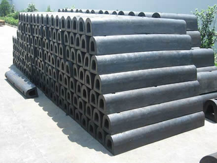 Several black DD rubber fenders are placed in the factory