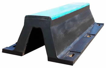 A black rubber arch fender with a layer of blue UHMW-PE to reduce the friction between the vessels and the dock.