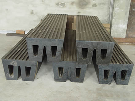 Several black standard W rubber fenders are placed in the storehouse.