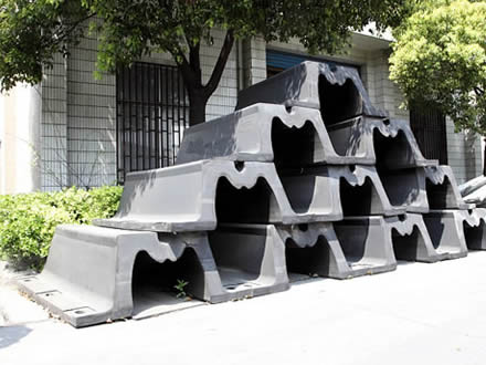 Several black modified arch fenders are placed in the factory.